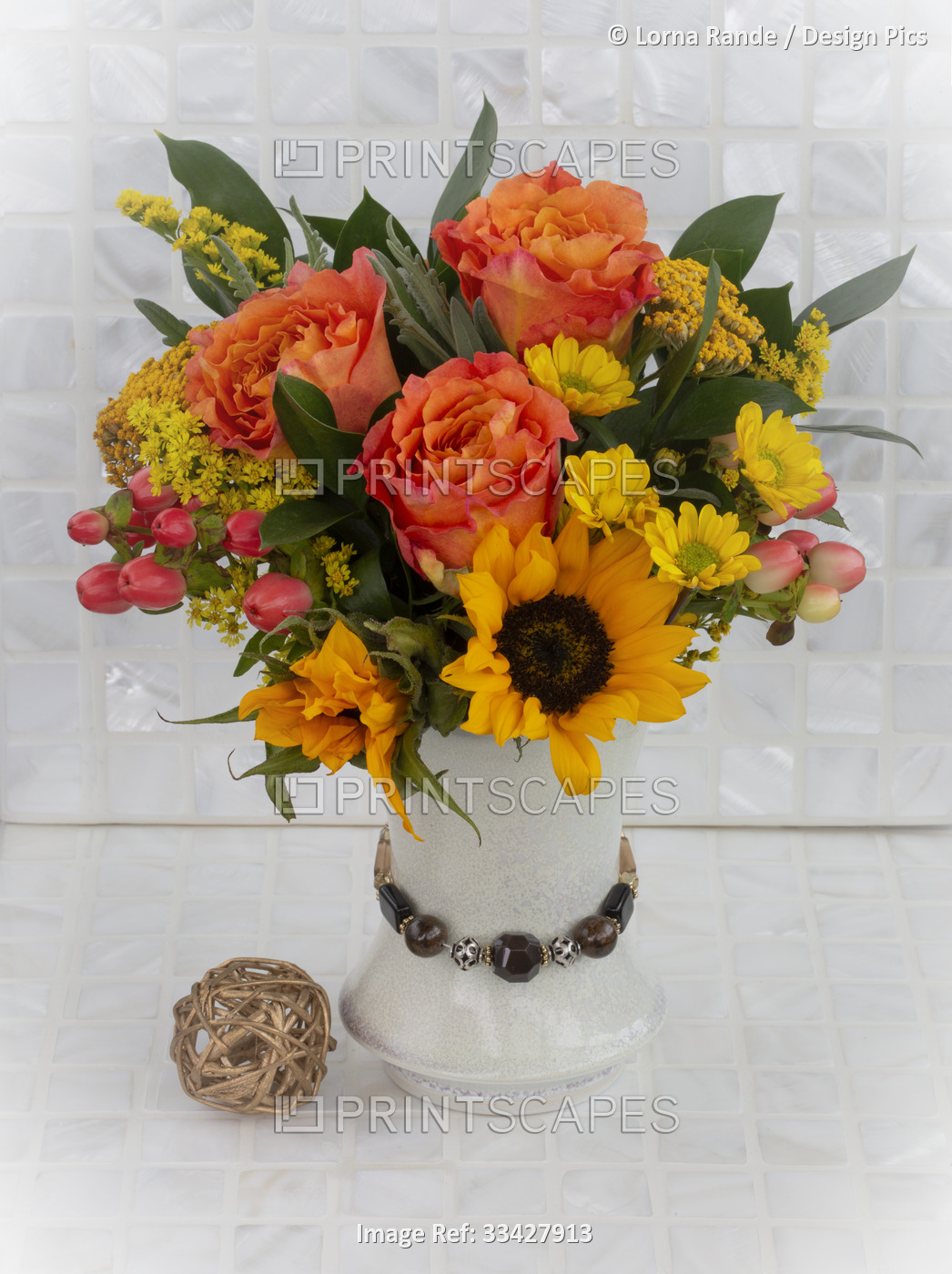 A beautiful and colourful bouquet of fresh cut flowers on a white tile surface; ...