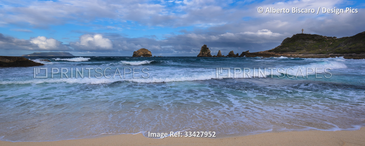 Waves and seasurf meeting the sandy beach at Grande-Terre with the Grand-Croix ...
