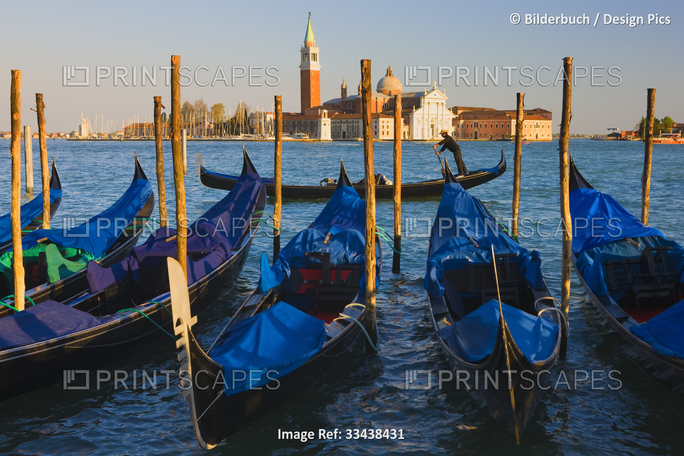 Gondolas with the church of Saint George Major in the background in Venice, ...