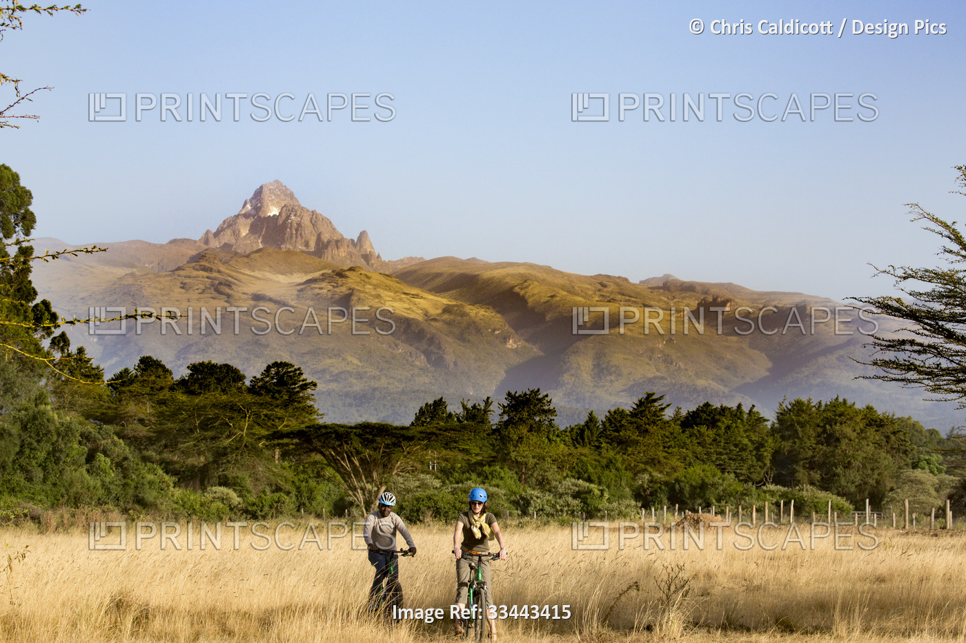 Tourist and guide on mountain bike riding safari in Mount Kenya National Park, ...