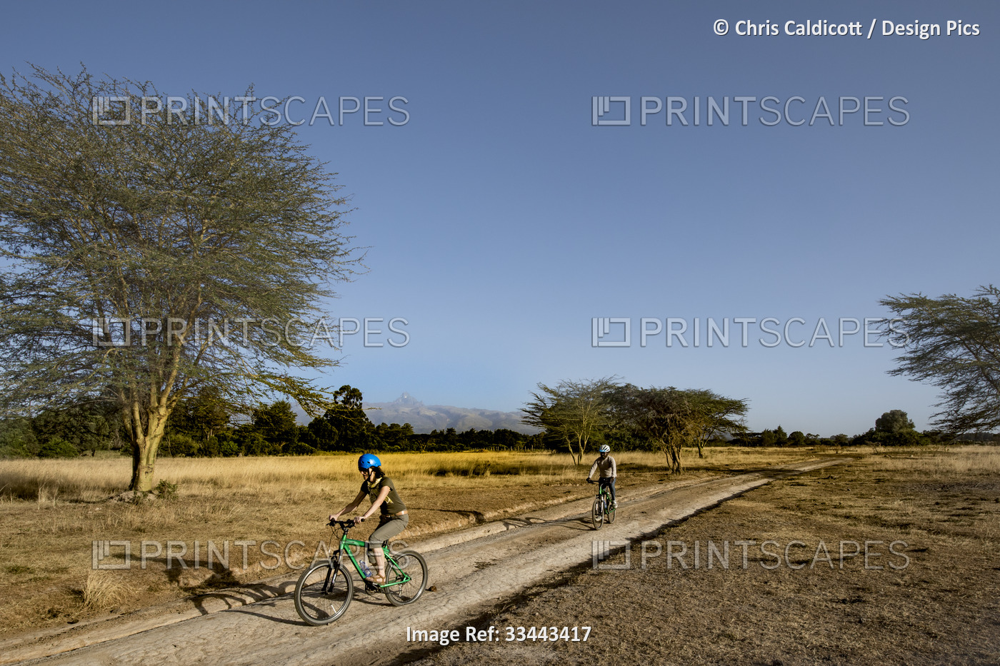 Tourist and guide on mountain bike riding safari in Mount Kenya National Park, ...