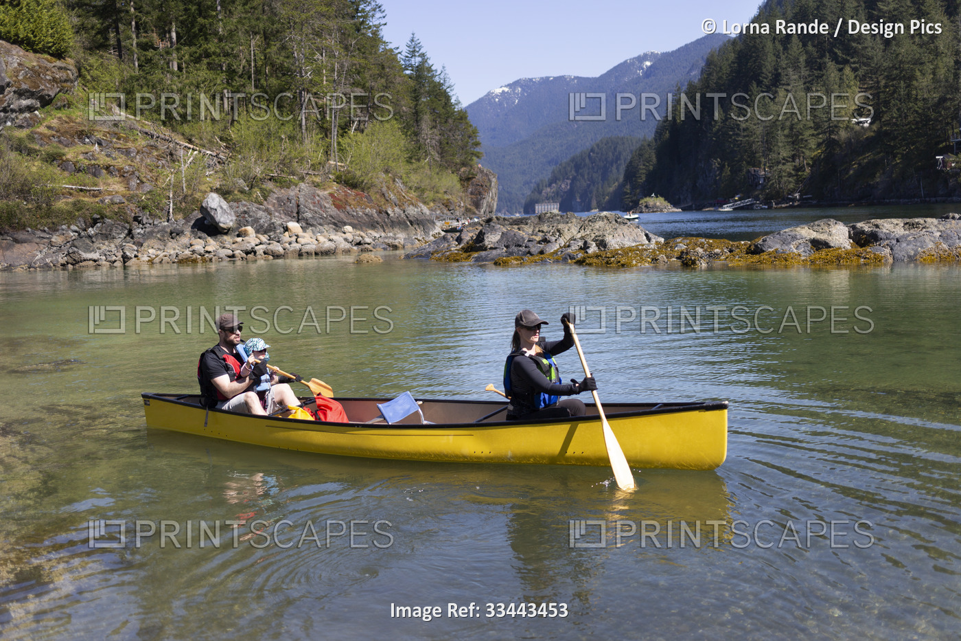 Young family going for a canoe ride along the coastline between Deep Cove Park ...