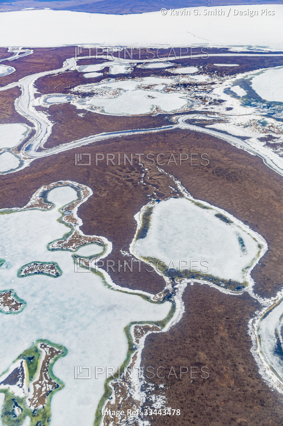 Aerial details of the tundra and melting ice on frozen ponds in Spring; ...