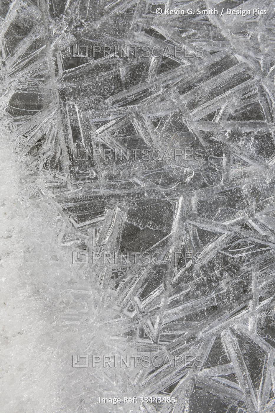 Close-up of ice crystal details in the melting snow and ice lining the shore of ...