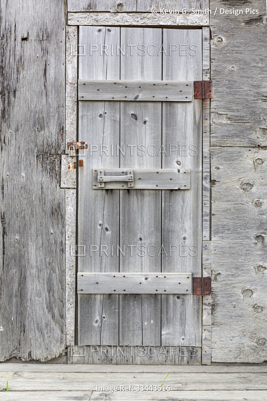 A weathered wooden door on a plywood sided shed in Summer, Lower Yukon River; ...