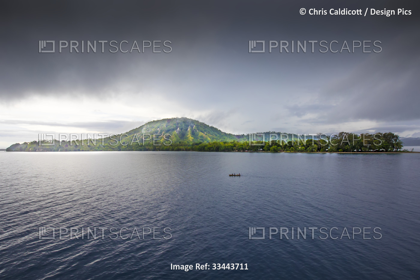 People in a canoe in front of the island jungles of Dobu Island with steam ...