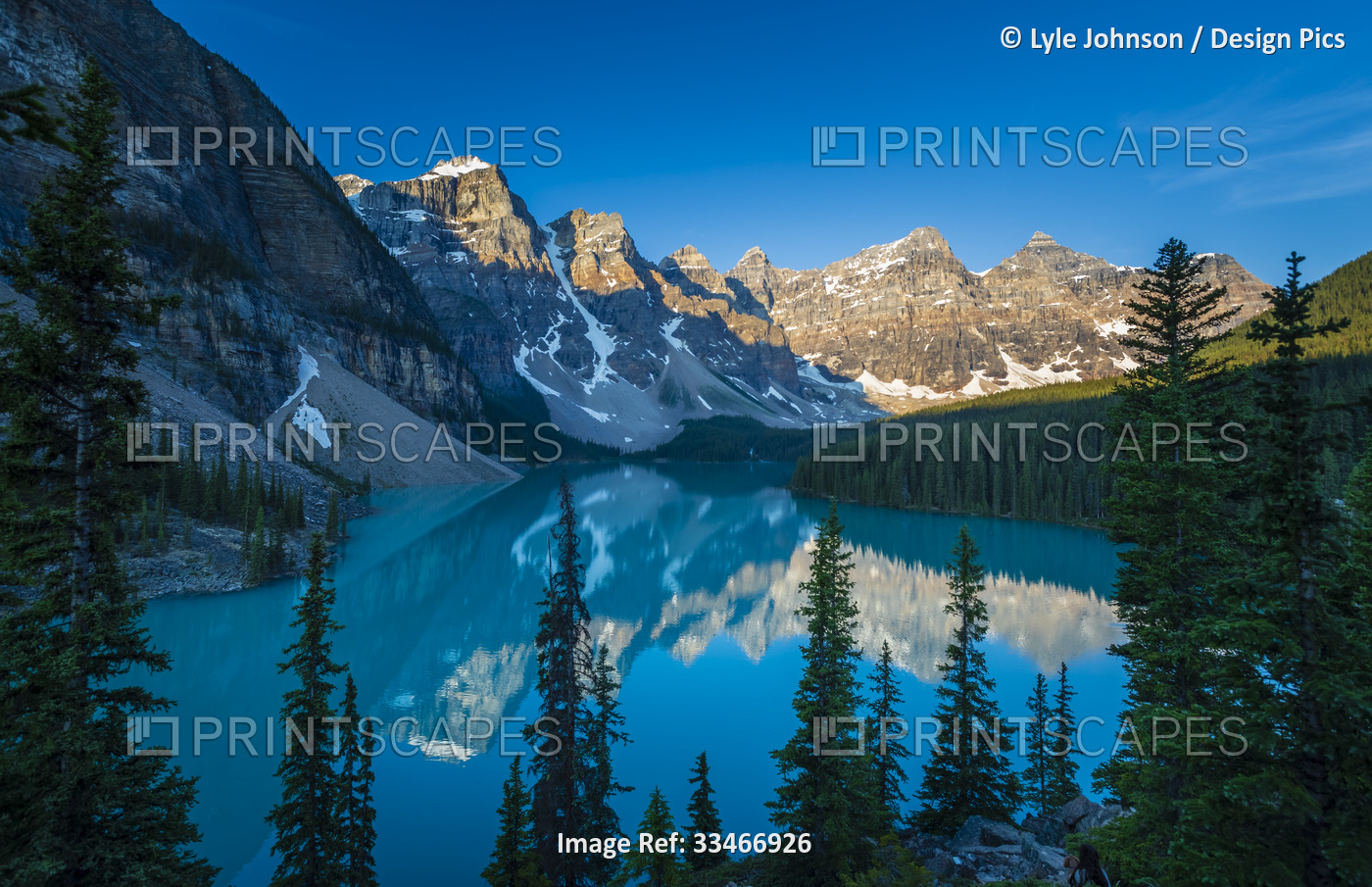 Valley of the Ten Peaks reflected in the tranquil water of Moraine Lake under a ...