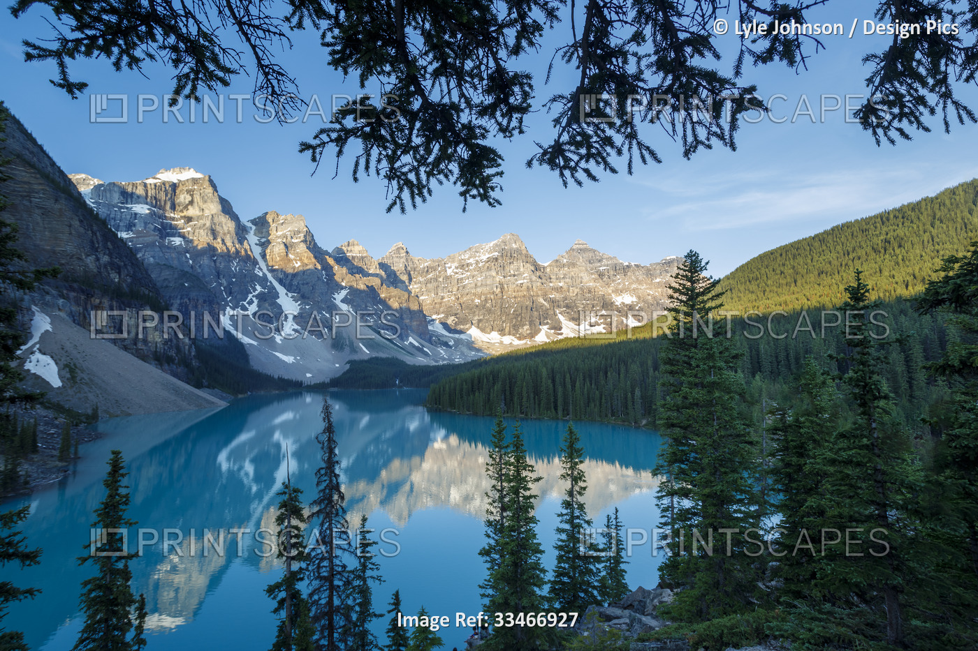 Valley of the Ten Peaks reflected in the tranquil water of Moraine Lake under a ...