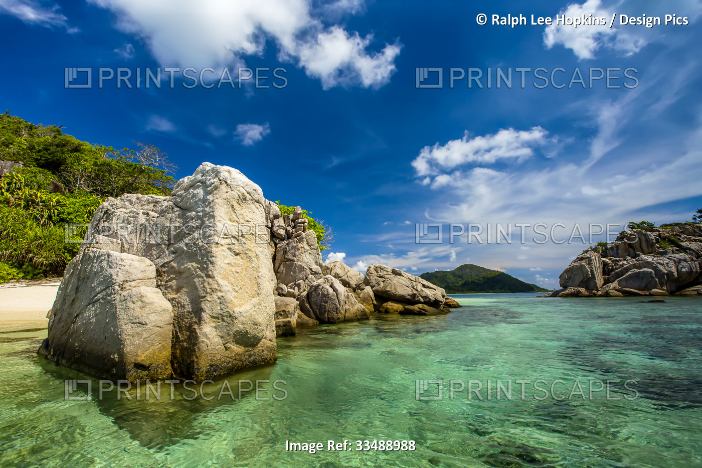 Granite rock formations define a tropical beach.