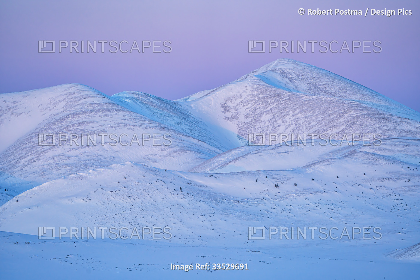 Sunset light on the snow covered mountains of the Richardson Range near the ...
