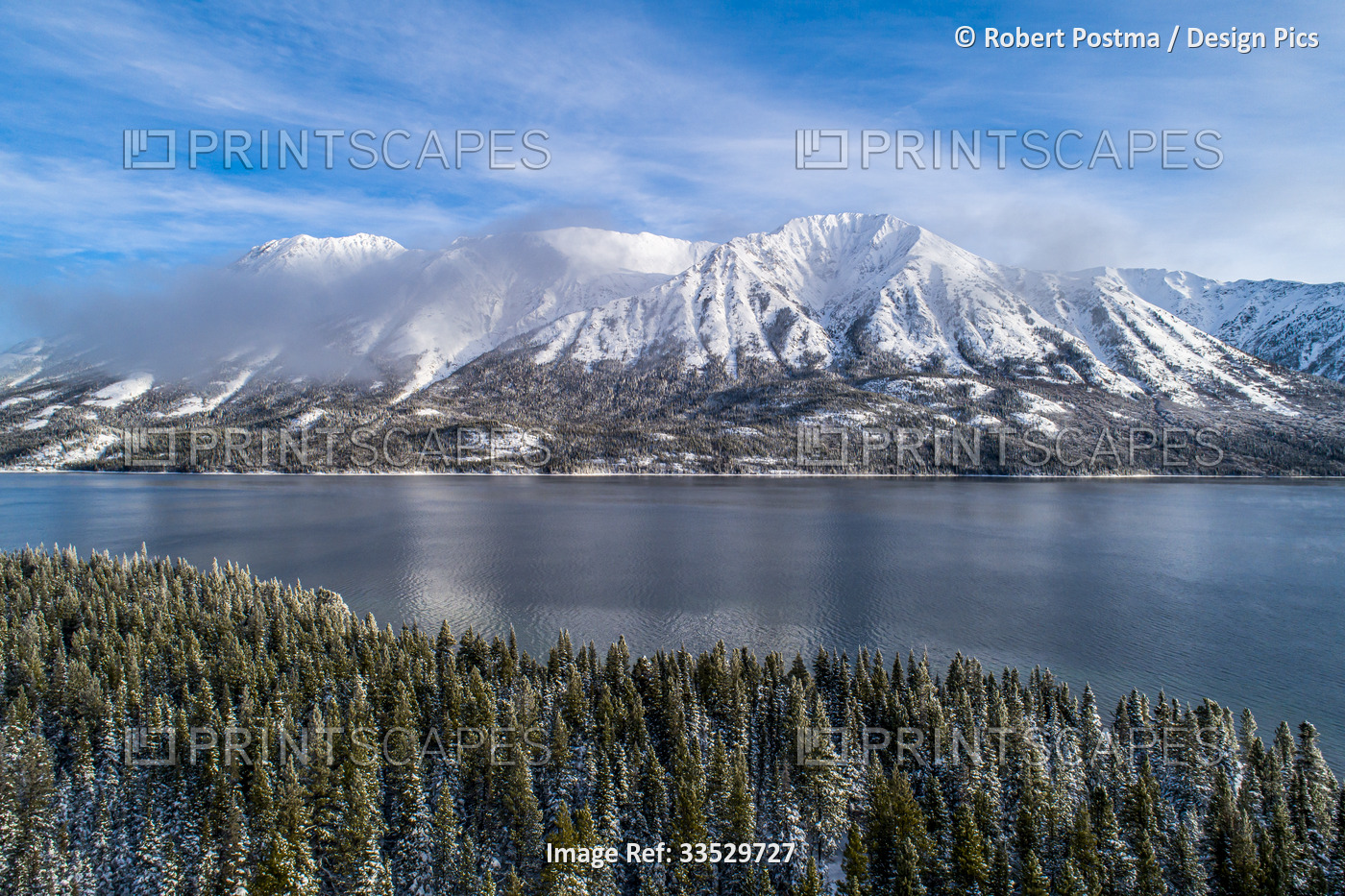 Beautiful landscape of Tutshi Lake with snow capped mountains in early spring; ...