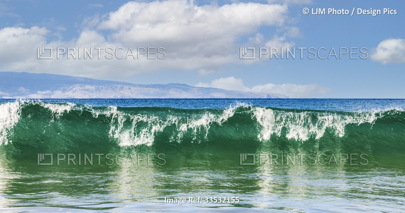 Breaking wave and surf rolling into the shore at D.T. Fleming Beach with a view ...