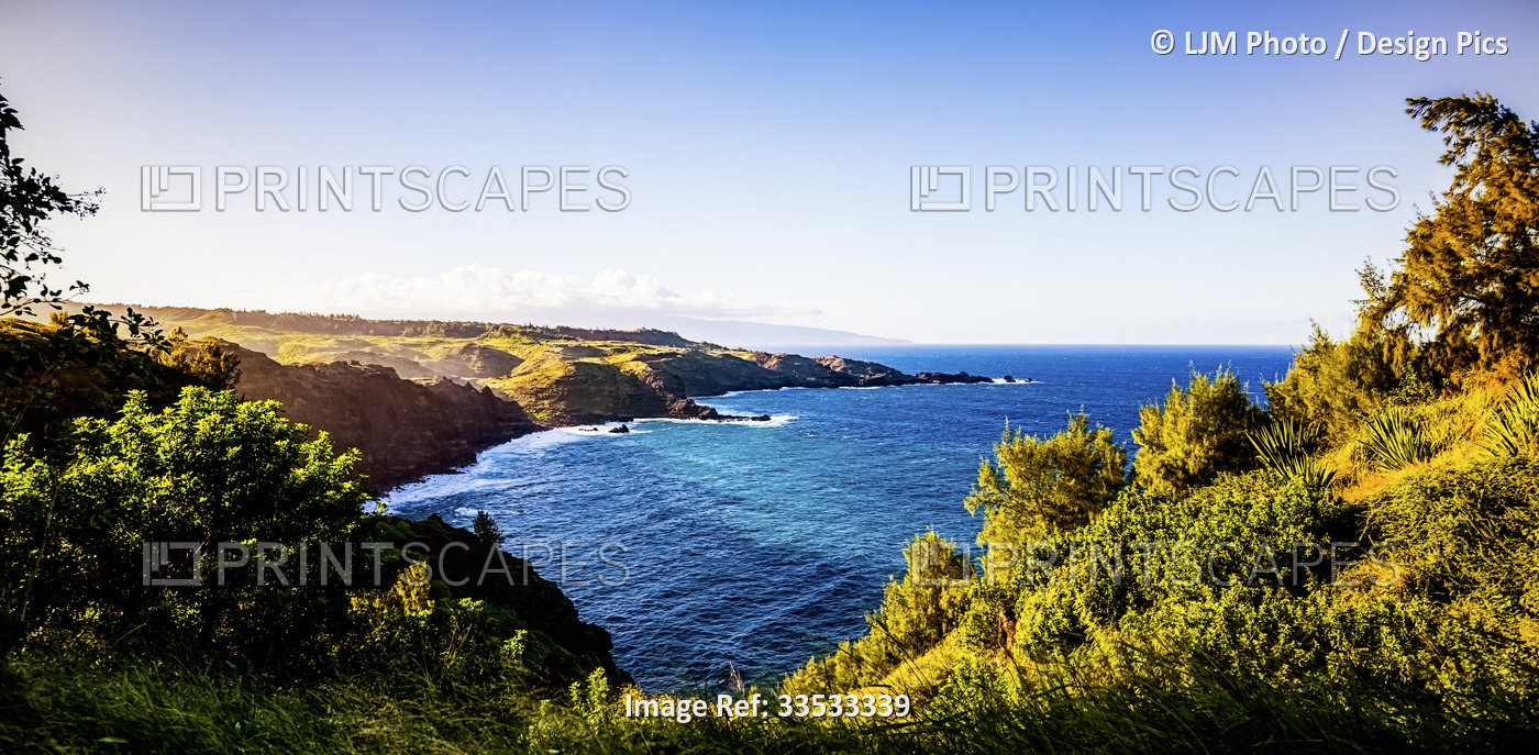 The rugged coastline of North West Maui covered in lush, green foliage; Maui, ...