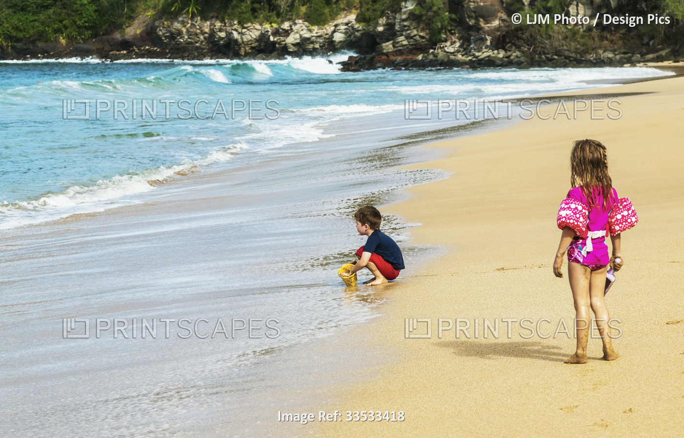 Children playing in the sand on D. T. Fleming beach at the water's edge; ...