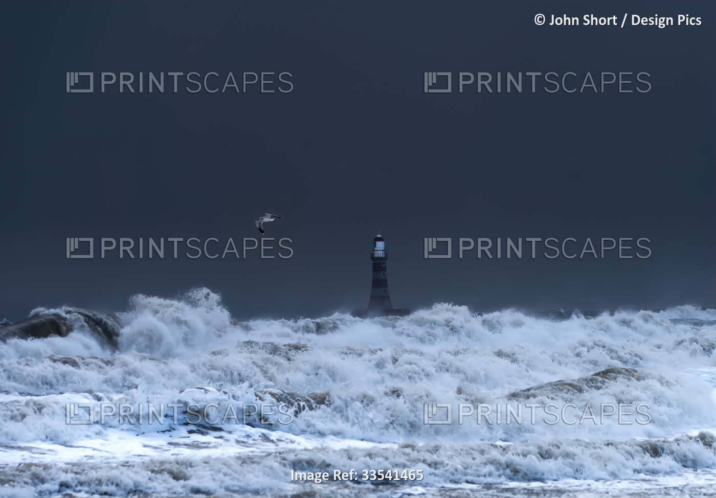 Roker Lighthouse and stormy waters splashing in the foreground; Sunderland, ...