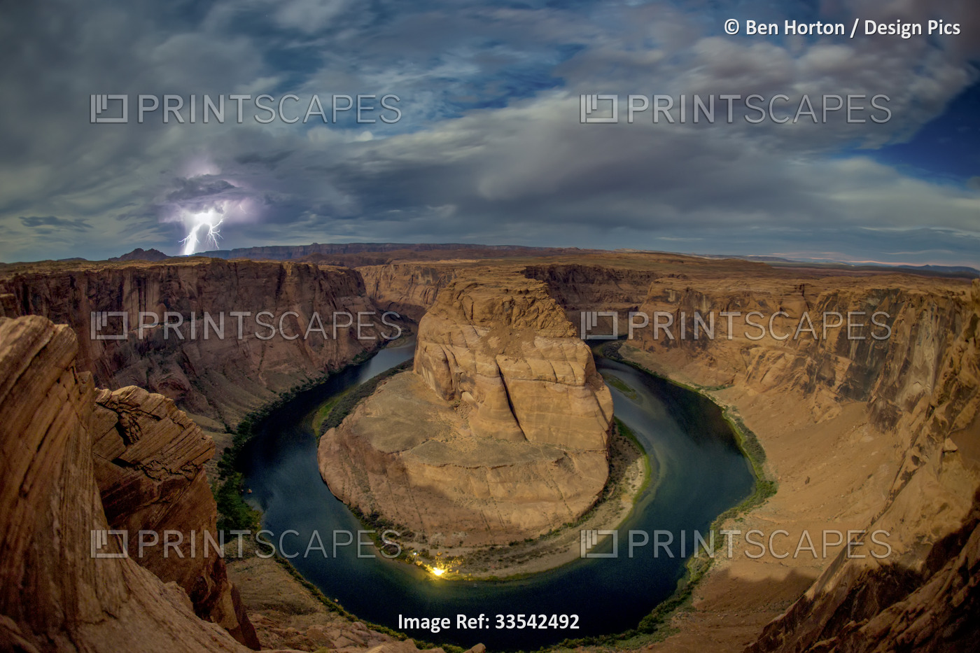 Lightning strikes over the Horseshoe Bend of the Colorado River at night; Page, ...