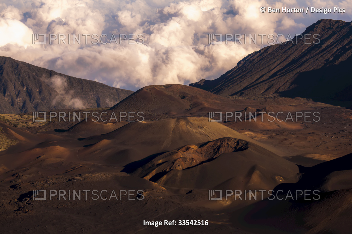 Haleakala Crater at sunset with clouds in the background, surrounded by ...