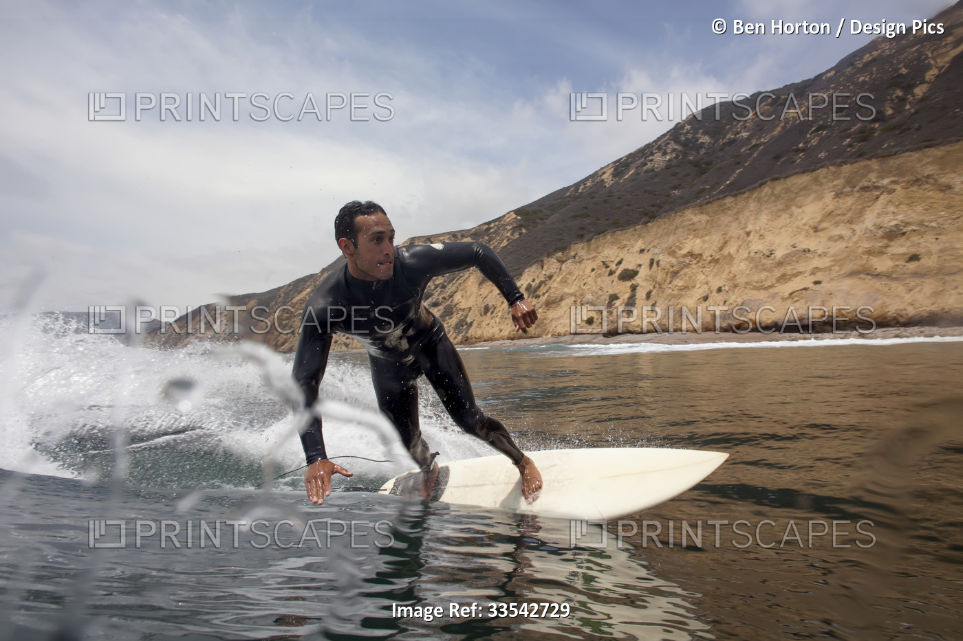 A surfer makes a bottom turn in the cold water of the Channel Islands.