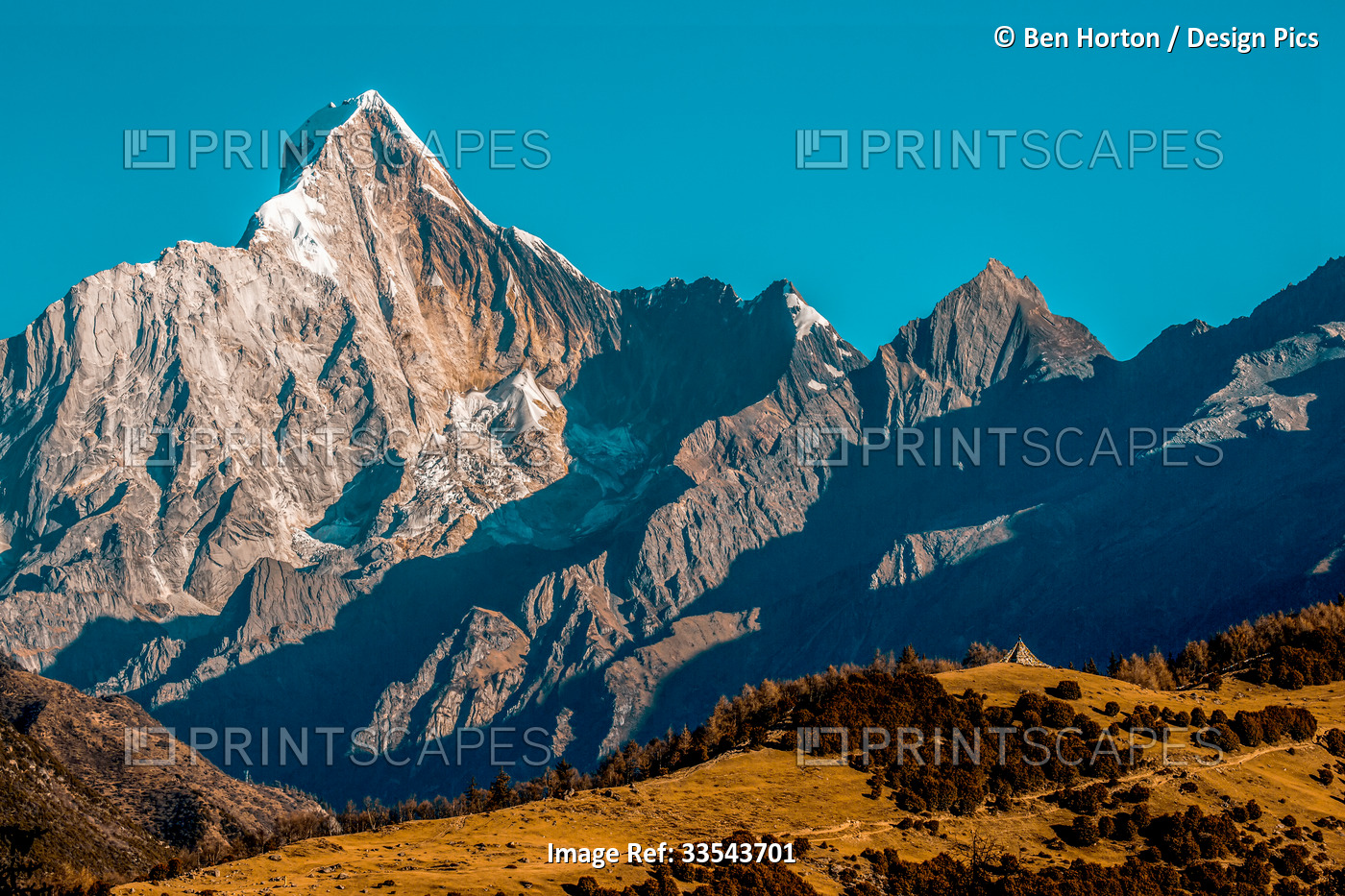 Rugged mountainous terrain of Mount Siguniang under a bright blue sky, ...