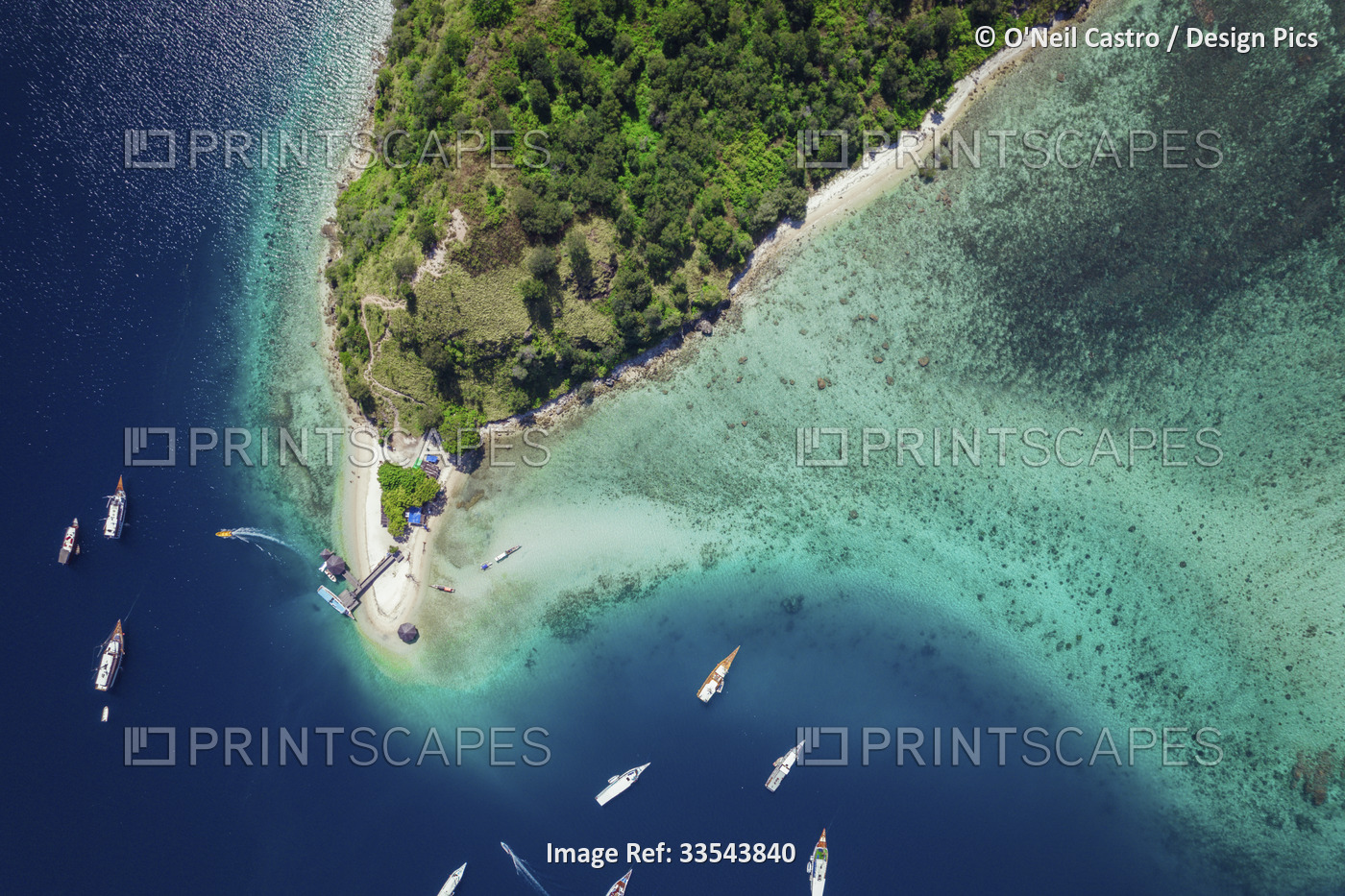 View from directly above of boats moored in the water off Batu Bolong Beach in ...