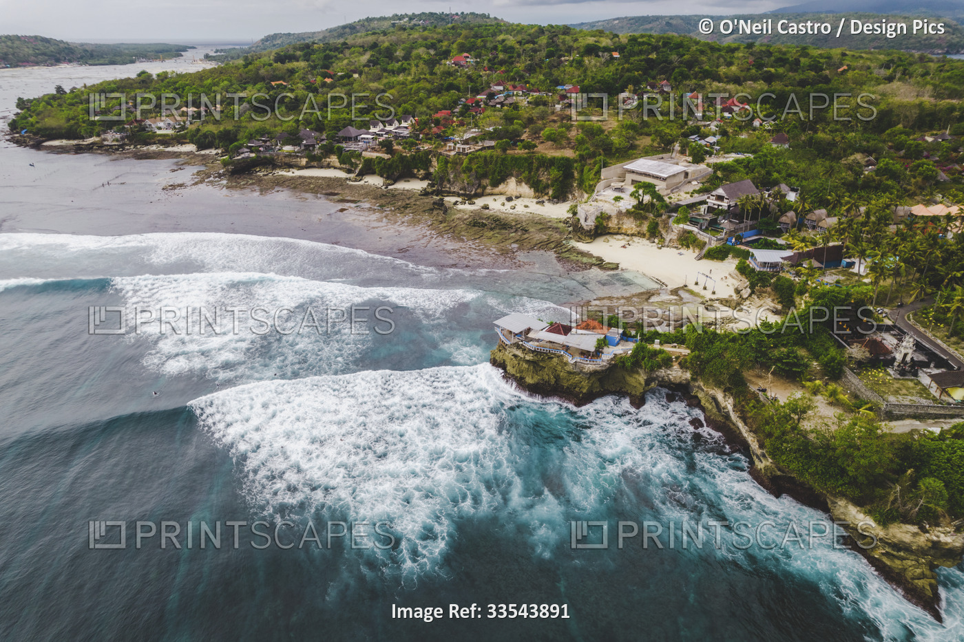 Aerial view of the sea surf and rolling waves along the beachfront of the ...
