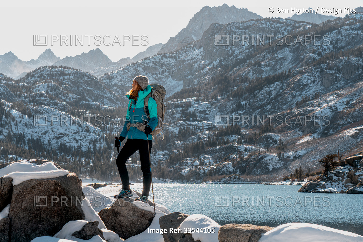 A woman hiking in the Eastern Sierra in winter; Bishop, California, United ...