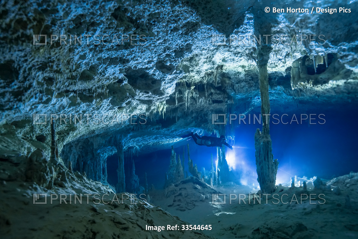 A cave diver explores a limestone passage; Tulum, Quintana Roo, Mexico