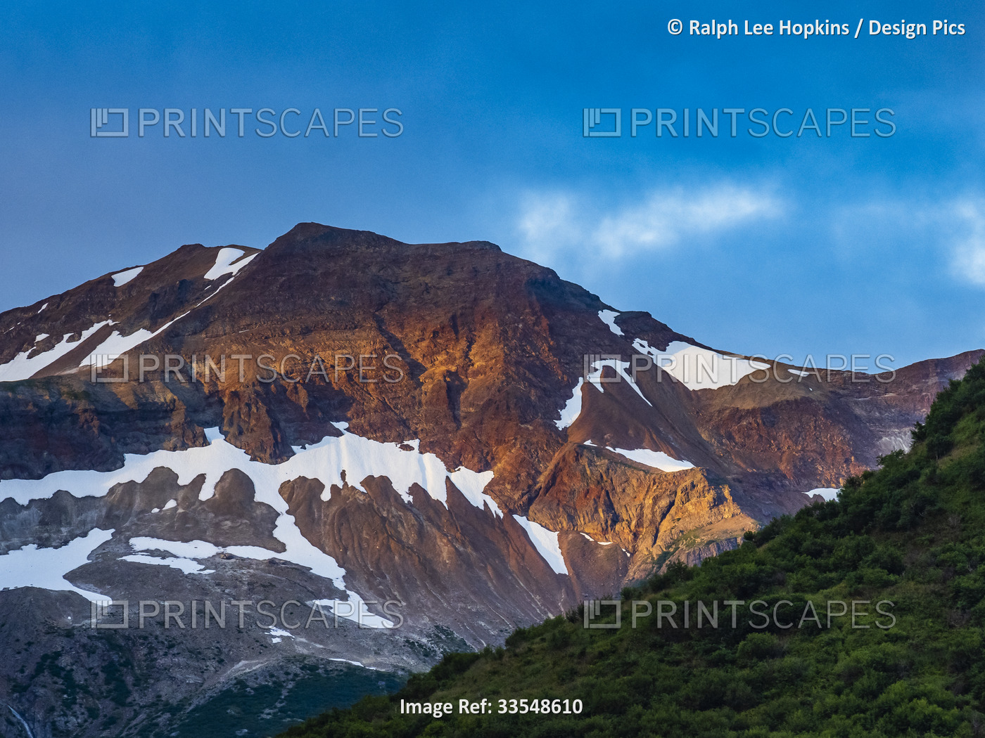 Sunset light over mountain peak in Geographic Harbor; Katmai National Park and ...