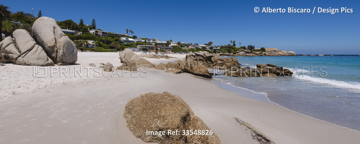 Beachfront homes and large boulders along the Atlantic Ocean at Clifton Beach; ...