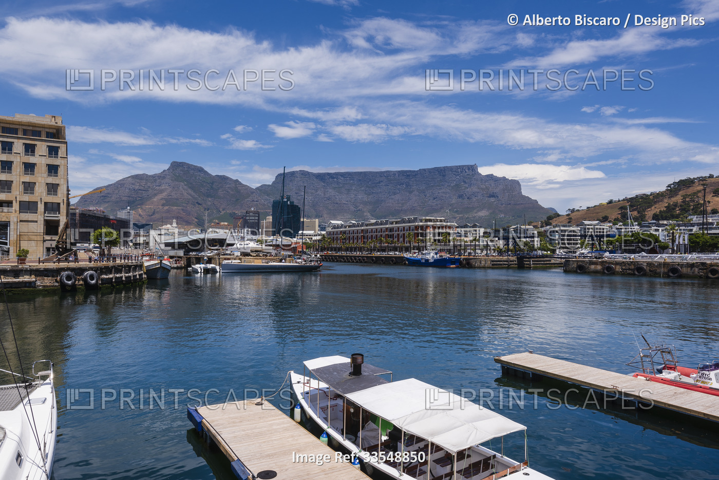 Boats moored along the harbor at the Victoria and Alfred Waterfront in Cape ...