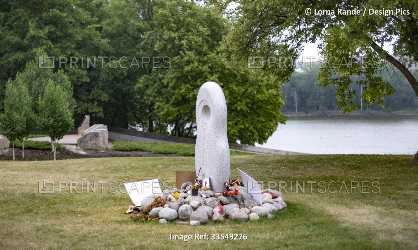 In The Forks Winnipeg, an art piece stands in a public park with many items ...