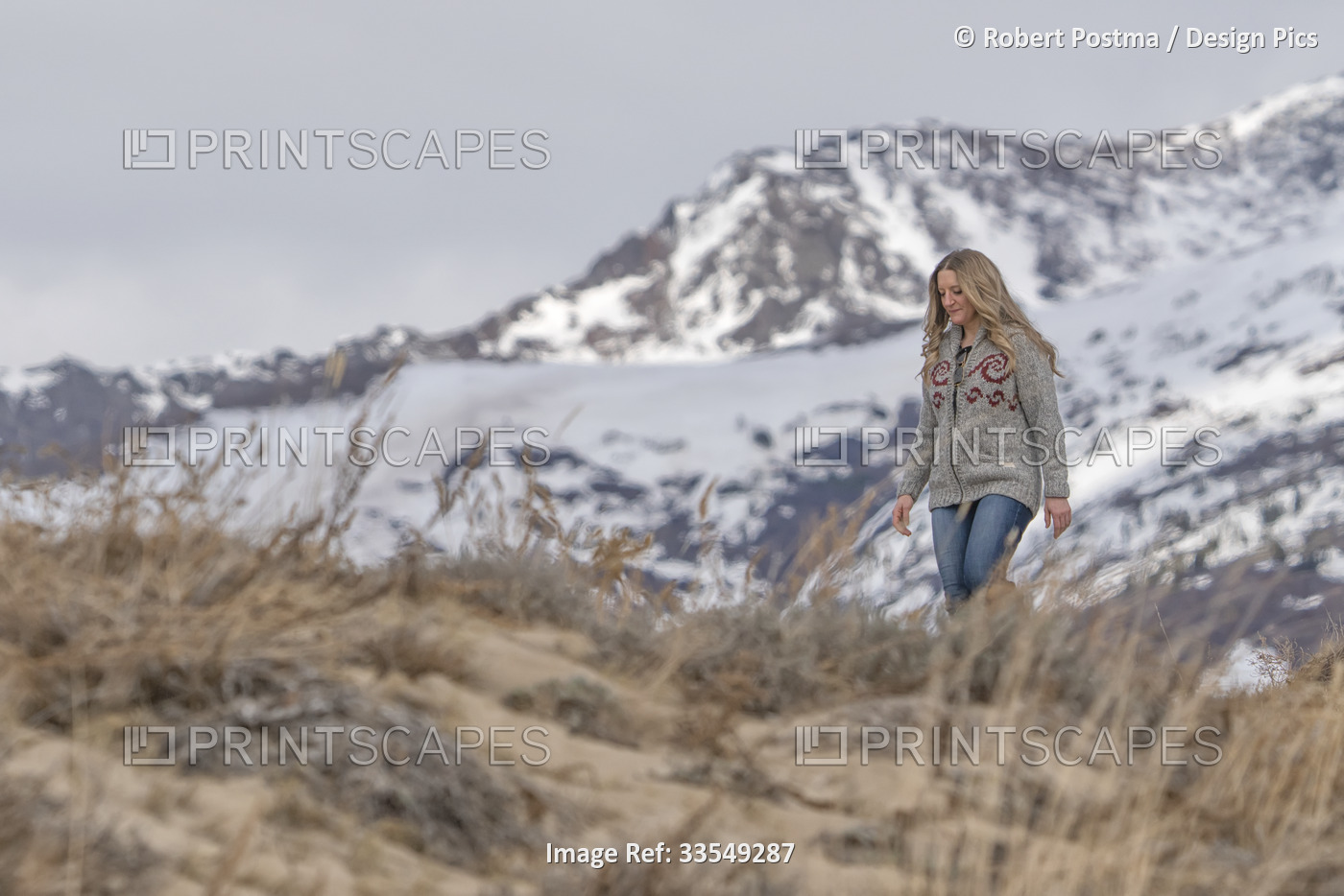 Woman walking through the sand dunes around Carcross; Carcross, Yukon, Canada