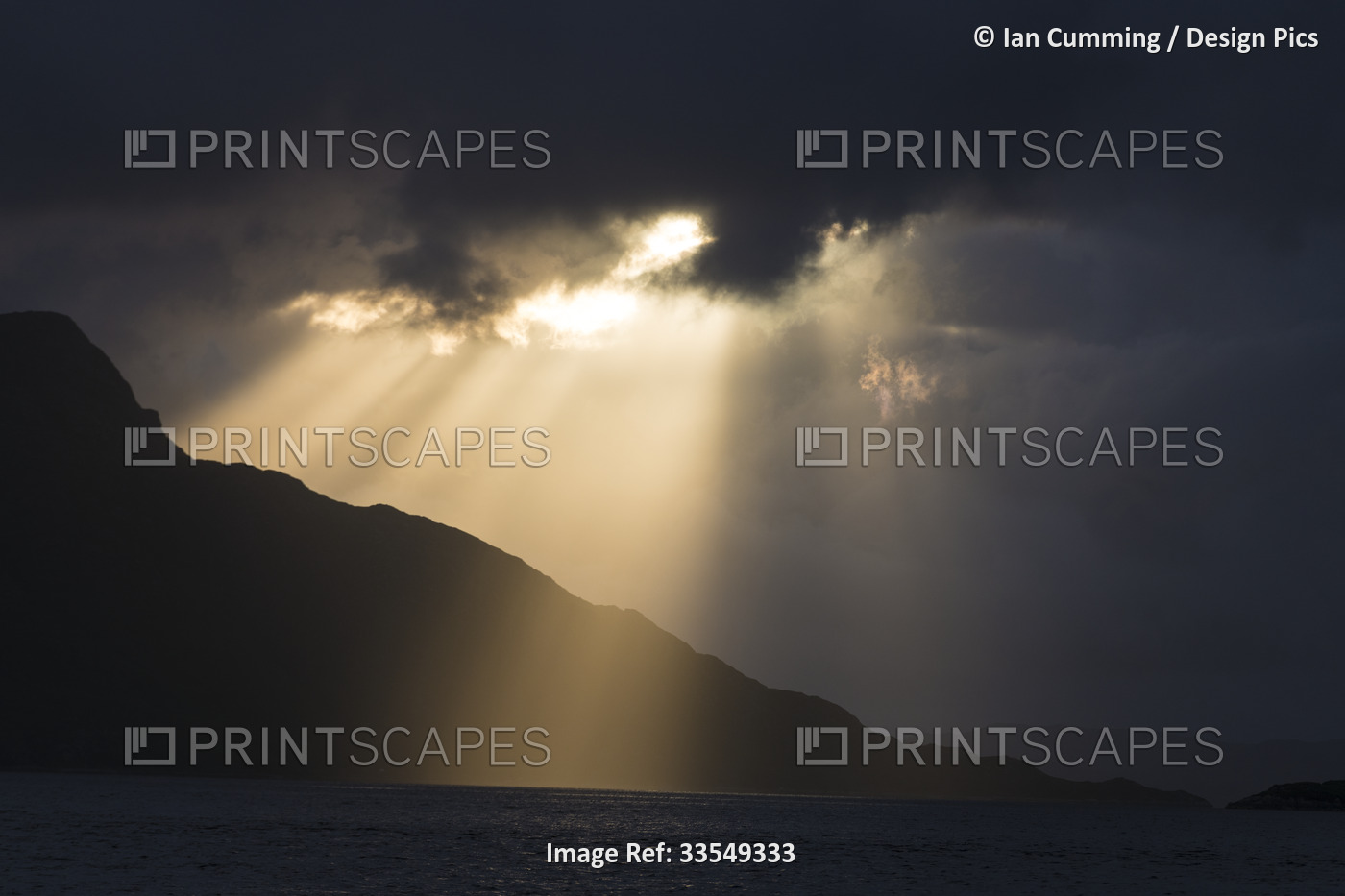 Atlantic Ocean and silhouette of the coastal mountains at sunset near ...