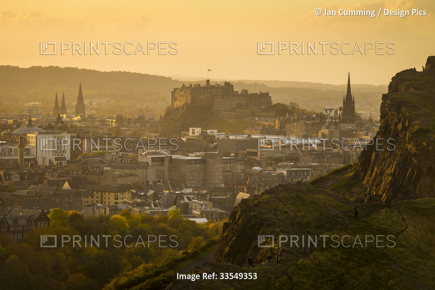 Looking across from Arthur's Seat to Edinburgh Castle and city at dusk; ...