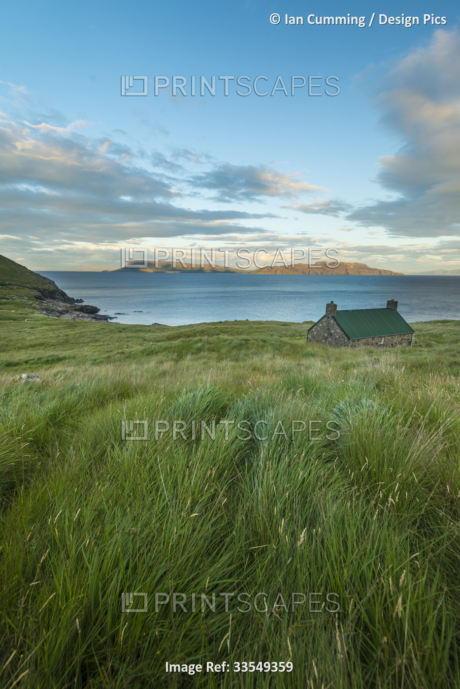 Dibidil Bothy at dusk with the Isle of Eigg in the background, Rum; Scotland, ...
