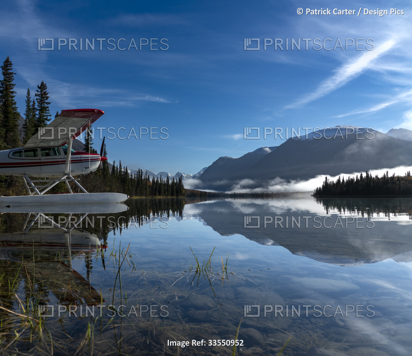 Silhouetted mountains reflected in the calm water of Kontrashibuna Lake and a ...