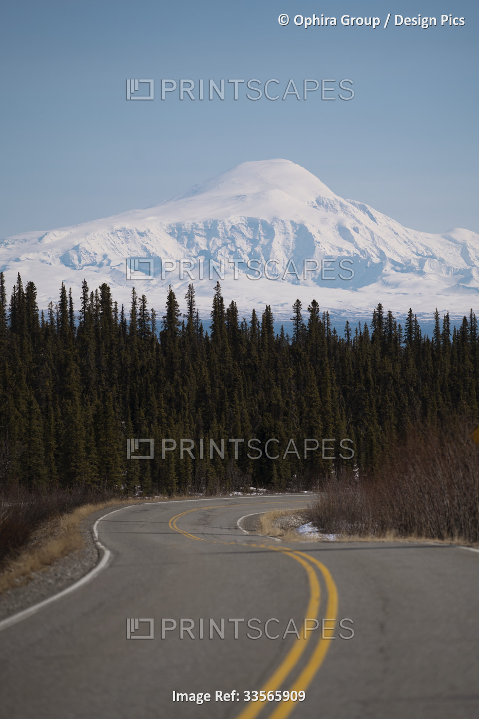 Snow and glacier covered Mt. Drum rises above the Glenn Highway and the black ...
