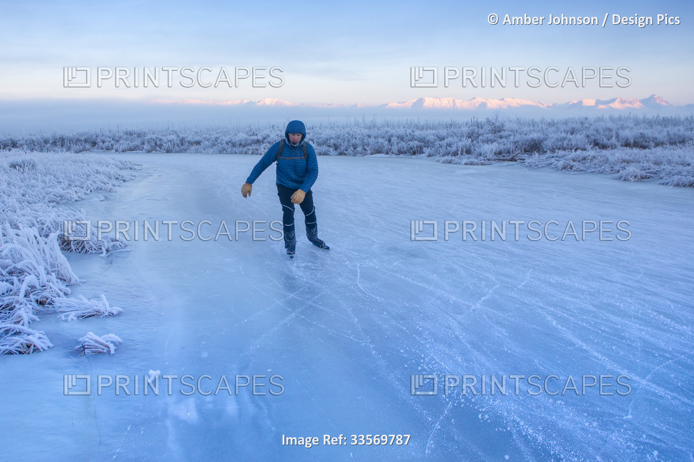 A caucasian man backcountry ice skating, nordic blading, on wild ice of Rabbit ...