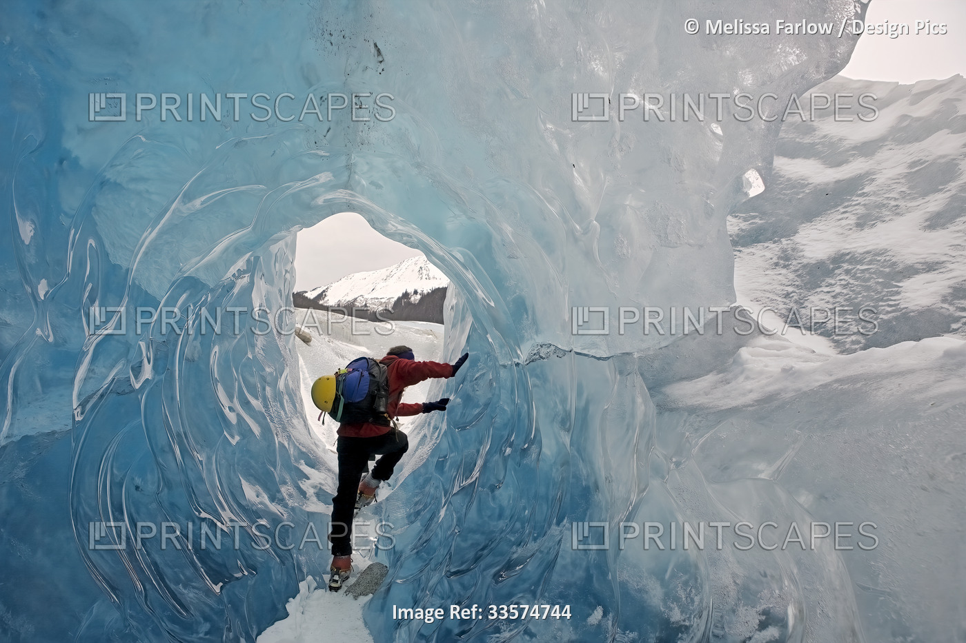 View taken from behind of a hiker, equipped with crampons and emergency ...