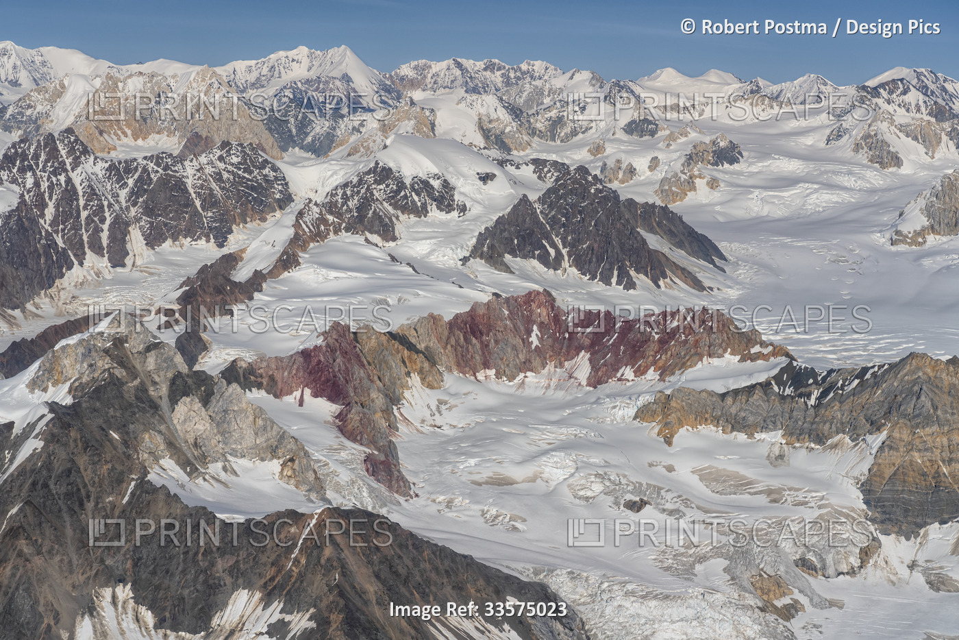 Aerial view of the jagged mountain peaks revealing red rock faces and the ...
