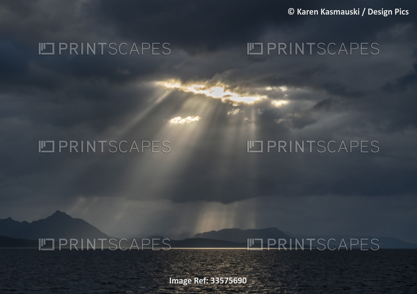 Sunlight breaking through clouds in Alaska's Chatham Strait area, part of the ...