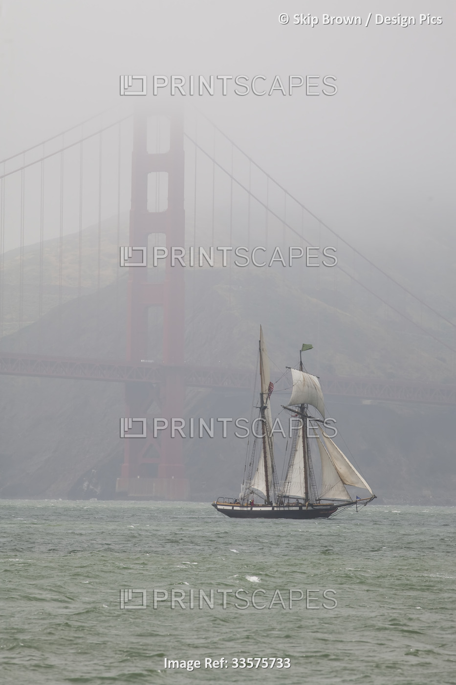 A two masted schooner sails under the Golden Gate Bridge.; San Francisco, ...