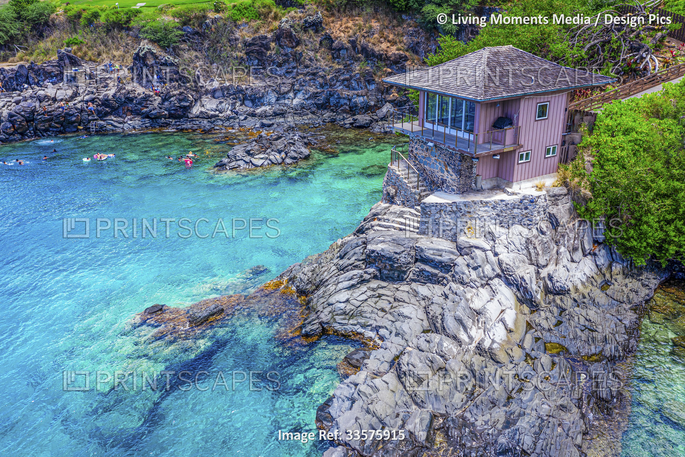 Clifftop venue for private events and swimmers in the water along the rocks on ...