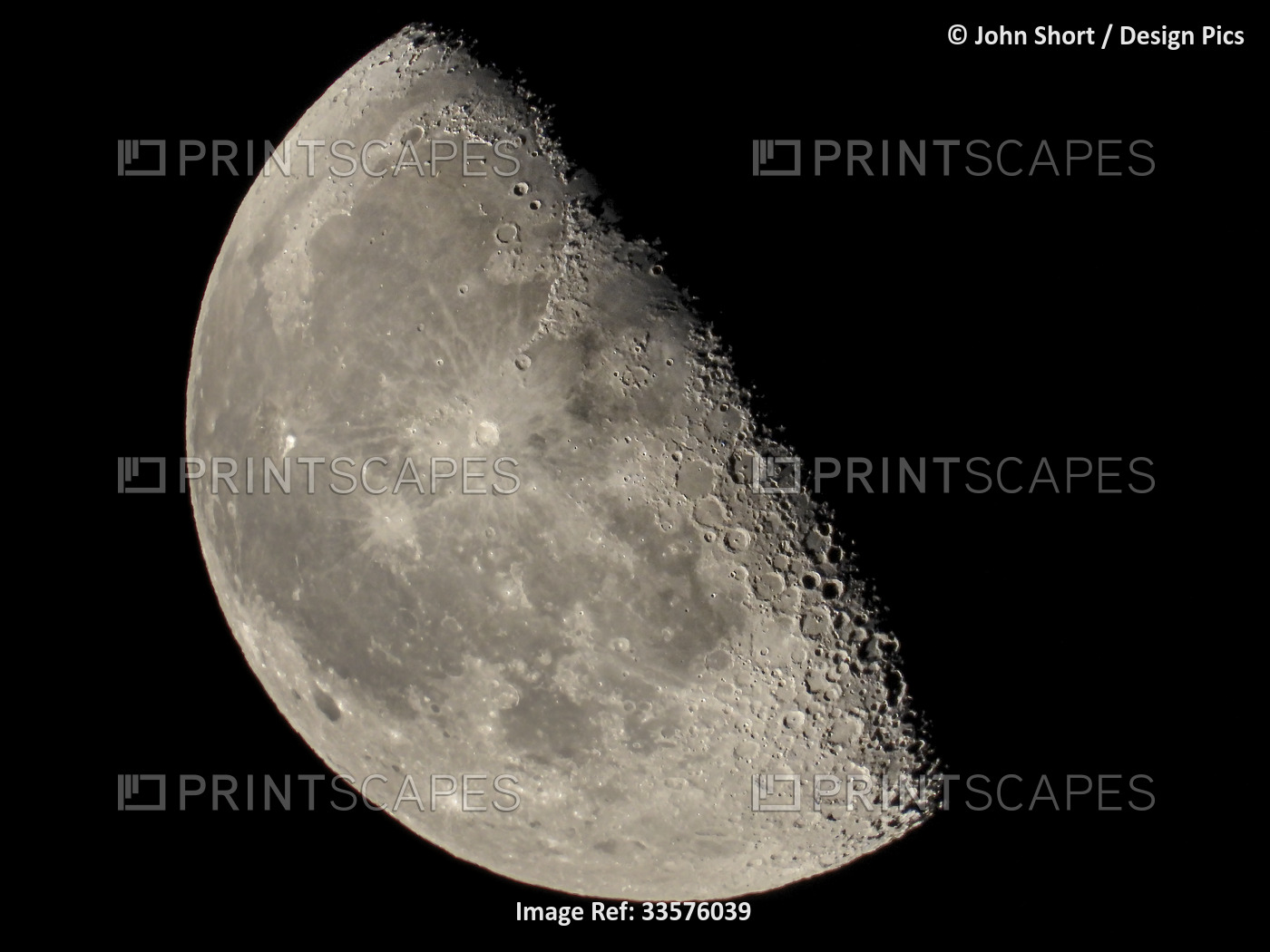 Half moon illuminated in a dark sky with details of the surface; South Shields, ...