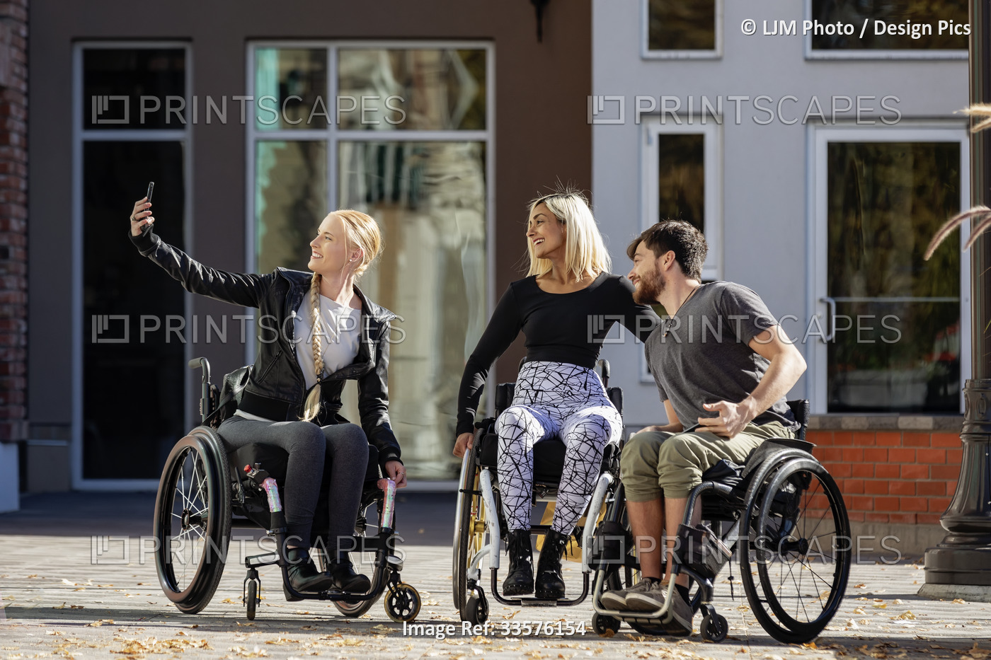 Three young paraplegic friends spending time together shopping and taking a ...