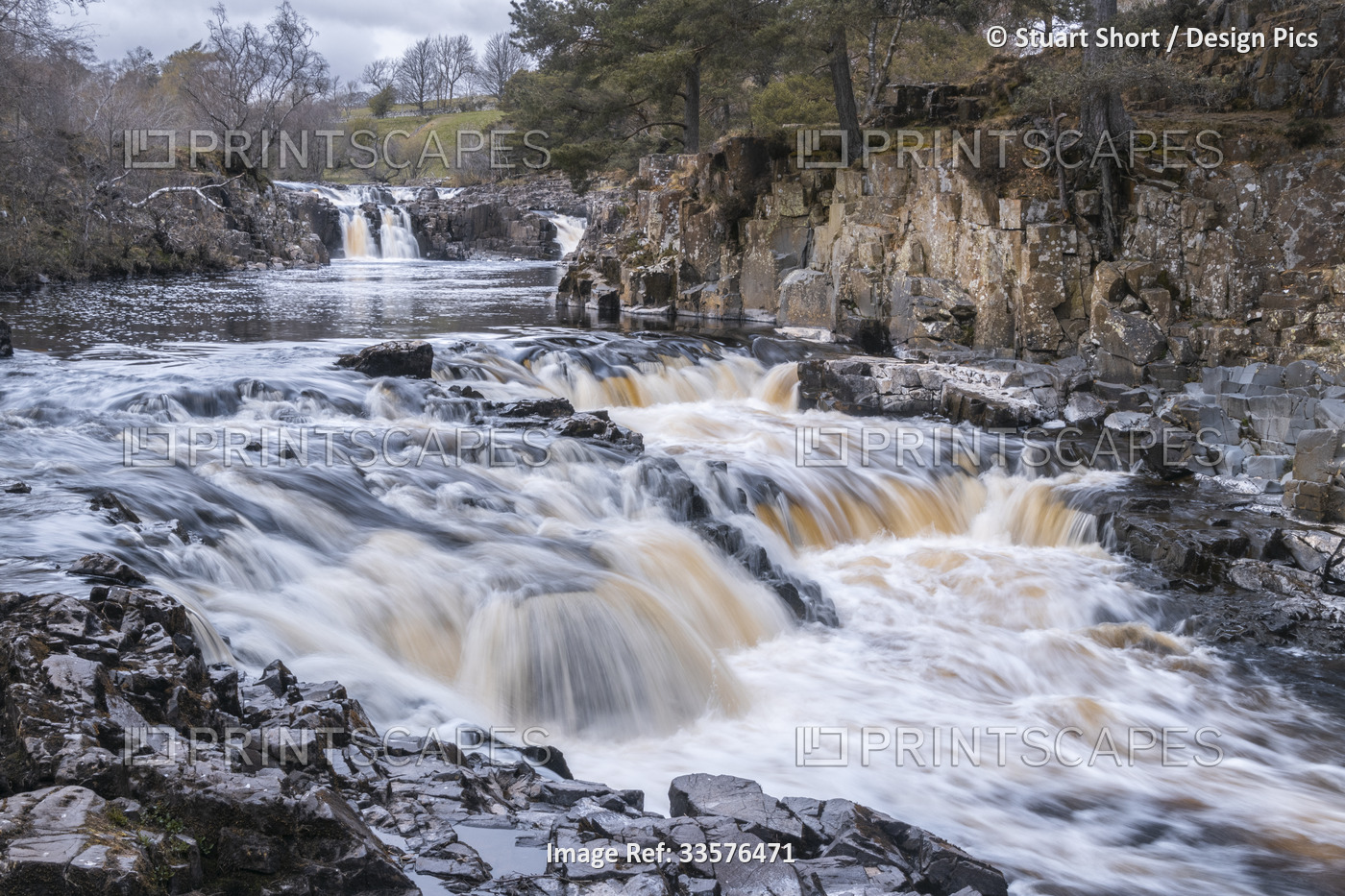 A fast flowing River Tees drops over multiple falls in northern England; Low ...