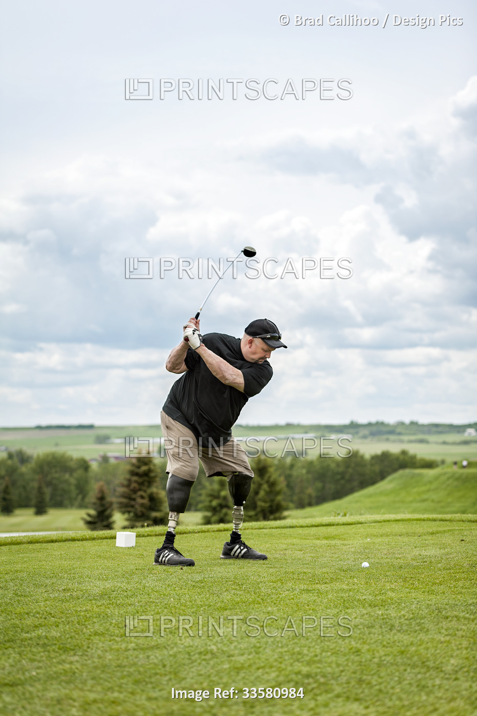 Double amputee with leg prosthetics on the golf course; Okotoks, Alberta, Canada