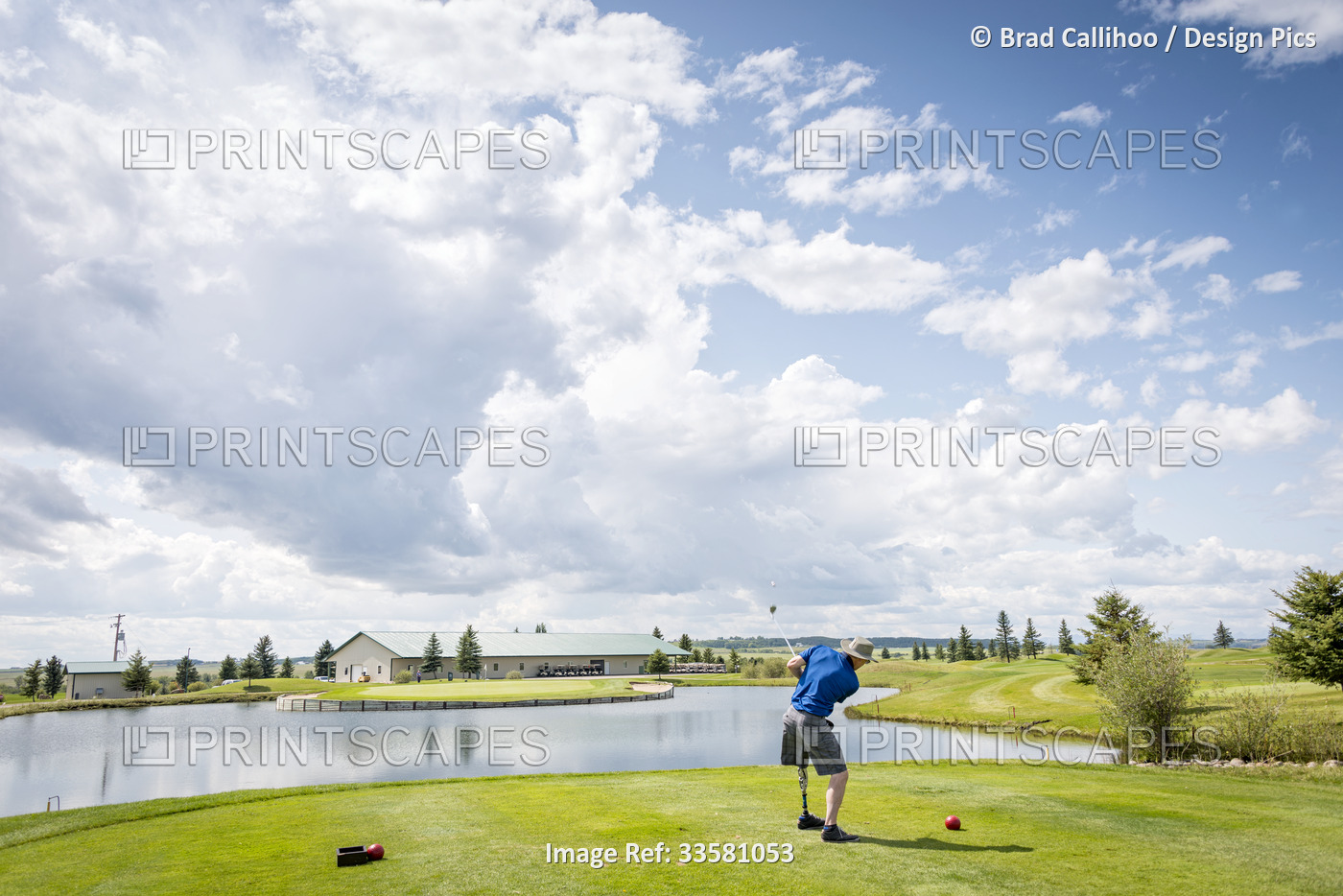 Amputee with leg prosthesis driving the ball on the golf course; Okotoks, ...