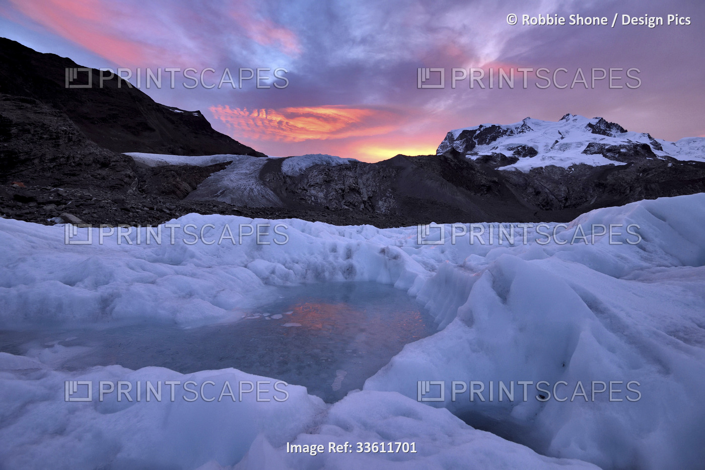 Frozen pool of water on the ice of the Gorner Glacier at sunrise.; Gornergrat, ...