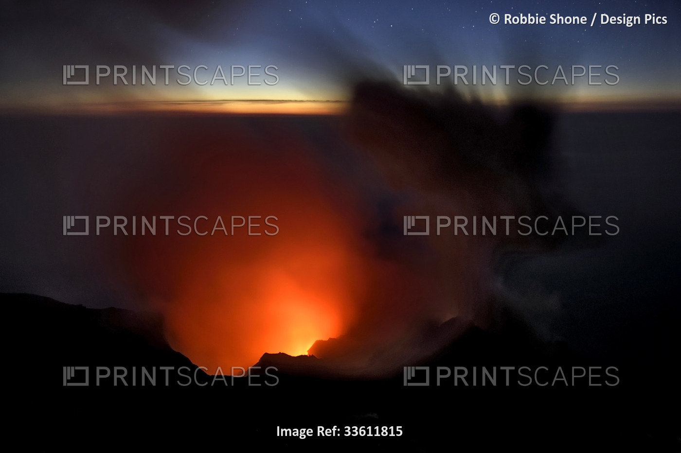 Smoke and ash rise up out of a volcano crater and into the evening sky.; ...